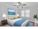 Tastefully decorated bedroom featuring a comfortable bed, modern lighting, and calming ocean view artwork at 7252 Coventry Ct, Weeki Wachee, FL 34607