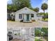 Charming exterior view of home featuring a teal door and neutral color palette at 7252 Coventry Ct, Weeki Wachee, FL 34607