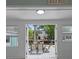 View from sunroom French doors of outdoor deck with seating and a serene canal waterfront at 7252 Coventry Ct, Weeki Wachee, FL 34607