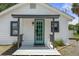 Close-up of home's teal front door, showcasing charm and curb appeal at 7252 Coventry Ct, Weeki Wachee, FL 34607