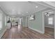 Hallway with TV and kitchen area featuring modern appliances and finishes for a seamless living experience at 7252 Coventry Ct, Weeki Wachee, FL 34607