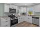 Well-lit kitchen showcasing white cabinets, stainless steel appliances, and plenty of counter space at 7252 Coventry Ct, Weeki Wachee, FL 34607