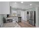 Modern kitchen with stainless steel appliances and marble countertops offers a stylish cooking space at 7252 Coventry Ct, Weeki Wachee, FL 34607