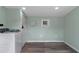 Laundry room with modern washer and dryer, light green walls and wood-look floors at 7252 Coventry Ct, Weeki Wachee, FL 34607