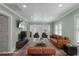 Staged living room with modern floors, a wall-mounted television, and leather seating arranged around a coffee table at 7252 Coventry Ct, Weeki Wachee, FL 34607