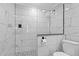 Modern shower features glass enclosure and gorgeous, light, marble-style tiling and mosaic tile flooring at 7252 Coventry Ct, Weeki Wachee, FL 34607