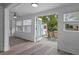 Bright sunroom features white wood paneling, ceiling fan, and access to the deck with outdoor seating at 7252 Coventry Ct, Weeki Wachee, FL 34607