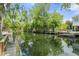 Scenic waterfront view with docks, lush foliage, and inviting boat access, perfect for a relaxing lifestyle at 7252 Coventry Ct, Weeki Wachee, FL 34607