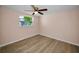Bright bedroom with hardwood floors and a ceiling fan at 7321 Parrot Dr, Port Richey, FL 34668