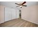 Bright bedroom with hardwood floors, closet, and ceiling fan at 7321 Parrot Dr, Port Richey, FL 34668