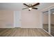 Well-lit bedroom with ample natural light, wood-look floors, and convenient closet space, offering a cozy retreat at 7321 Parrot Dr, Port Richey, FL 34668