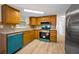 Updated kitchen with granite countertops, stainless steel appliances, ample cabinet space, and wood-look flooring at 7321 Parrot Dr, Port Richey, FL 34668