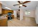 Modern kitchen with wood cabinets, granite countertops, stainless steel appliances, and wood-look flooring at 7321 Parrot Dr, Port Richey, FL 34668