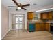 Kitchen featuring wood cabinets, granite countertops, and stainless steel appliances, with an adjacent dining area at 7321 Parrot Dr, Port Richey, FL 34668