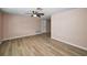 Spacious living room with wood-look flooring and neutral walls offers a versatile space for relaxation and entertainment at 7321 Parrot Dr, Port Richey, FL 34668