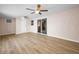 Living room with light wood floors, an air conditioner unit, and sliding glass doors to the backyard at 7321 Parrot Dr, Port Richey, FL 34668