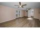 Spacious living room features light wood floors, two ceiling fans, and sliding glass doors to the backyard at 7321 Parrot Dr, Port Richey, FL 34668
