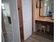 Ensuite bathroom featuring a vanity area with a stool and ample storage and adjacent toilet at 7508 Cypress Knee Dr, Hudson, FL 34667
