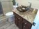 Bathroom featuring granite countertops, a clear sink bowl and glass enclosed shower at 7508 Cypress Knee Dr, Hudson, FL 34667
