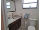 Well-maintained bathroom featuring a stylish vanity with a marble countertop and modern fixtures at 7508 Cypress Knee Dr, Hudson, FL 34667