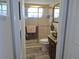 Bathroom including dark wood cabinets, granite countertops, glass shower and toilet at 7508 Cypress Knee Dr, Hudson, FL 34667