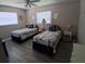 Bedroom featuring two twin beds, ceiling fan and two windows at 7508 Cypress Knee Dr, Hudson, FL 34667