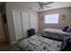 Bright bedroom featuring two twin beds, ceiling fan and two closets at 7508 Cypress Knee Dr, Hudson, FL 34667