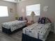 Bedroom featuring two twin beds, each decorated with seahorse pillows at 7508 Cypress Knee Dr, Hudson, FL 34667