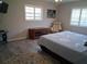 Serene bedroom featuring wood-look flooring, shuttered windows, and a calming color scheme at 7508 Cypress Knee Dr, Hudson, FL 34667