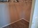 A walk-in closet features wood laminate flooring and a clothes rack for organization at 7508 Cypress Knee Dr, Hudson, FL 34667