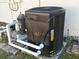 Image of the pool heating system. Includes filter and heater with pipes at 7508 Cypress Knee Dr, Hudson, FL 34667