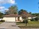 Charming single-story home featuring a well-maintained lawn and an attached two-car garage, under a blue sky at 7508 Cypress Knee Dr, Hudson, FL 34667