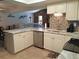 Charming kitchen with stone backsplash, neutral cabinets, and stainless-steel appliances at 7508 Cypress Knee Dr, Hudson, FL 34667