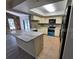 Updated kitchen with stone accent wall, stylish countertops, and stainless steel appliances at 7508 Cypress Knee Dr, Hudson, FL 34667