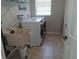 Laundry room including a utility sink and modern washer and dryer at 7508 Cypress Knee Dr, Hudson, FL 34667