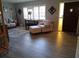 Inviting living area with wood-look floors, a large window with shutters, and comfortable seating at 7508 Cypress Knee Dr, Hudson, FL 34667