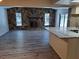 Spacious living area with stone fireplace and a kitchen island, with new floors throughout at 7508 Cypress Knee Dr, Hudson, FL 34667