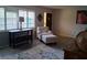 Comfortable living room featuring wood-look flooring, stylish decor, and a cozy reading nook at 7508 Cypress Knee Dr, Hudson, FL 34667