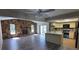 Open-concept living area featuring a stone fireplace, natural light, and a modern kitchen at 7508 Cypress Knee Dr, Hudson, FL 34667