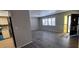 Living room area with vinyl floors, neutral paint, and natural light, with view to kitchen at 7508 Cypress Knee Dr, Hudson, FL 34667