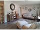 Cozy living room featuring neutral colors, a stylish cabinet, comfortable sofa, and decorative rug at 7508 Cypress Knee Dr, Hudson, FL 34667