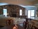 Inviting living room featuring a stone fireplace, vaulted ceilings, and sliding glass doors at 7508 Cypress Knee Dr, Hudson, FL 34667