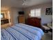 Bright Primary bedroom with comfortable layout, shuttered windows, and an en-suite bathroom at 7508 Cypress Knee Dr, Hudson, FL 34667