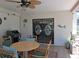 Relaxing screened-in patio area with ceiling fan, barbecue grill, dining furniture and sliding glass doors to interior at 7508 Cypress Knee Dr, Hudson, FL 34667
