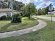 Street view showcasing well-maintained lawns and sidewalks in front of a charming residential property at 7508 Cypress Knee Dr, Hudson, FL 34667
