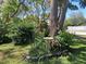 Mature trees and landscaping offer a serene setting in this lush garden at 7508 Cypress Knee Dr, Hudson, FL 34667