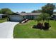 Charming single-story home with attached garage, well-manicured lawn, and mature landscaping at 8340 Divot Way, Port Richey, FL 34668