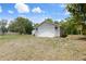 Detached garage with ample storage space surrounded by beautiful landscaping with a blue sky backdrop at 8493 Belmont Rd, Spring Hill, FL 34606
