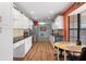 Open kitchen layout with stainless steel appliances, white cabinets, and a breakfast nook at 8493 Belmont Rd, Spring Hill, FL 34606
