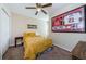 Bedroom featuring sports memorabilia, ceiling fan, and a closet at 8604 Corinthian Way, New Port Richey, FL 34654